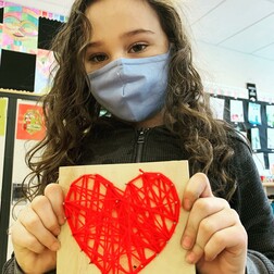 Student holding a heart