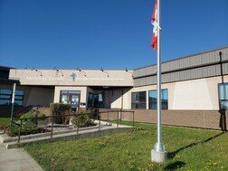 Half-mast Canada flag in front of Red Deer Catholic Regional Schools
