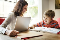 Mom helping her kid study 