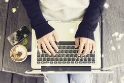 Girl reading on her laptop