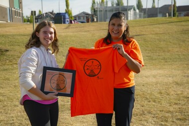 Ms. Diane Gardipy of the Indigenous Education Services Team presented Mya McCullough, a grade 9 student at St. Francis of Assisi Middle School, with a framed copy of her winning Orange Shirt Day design, as well as a copy of the final shirt.